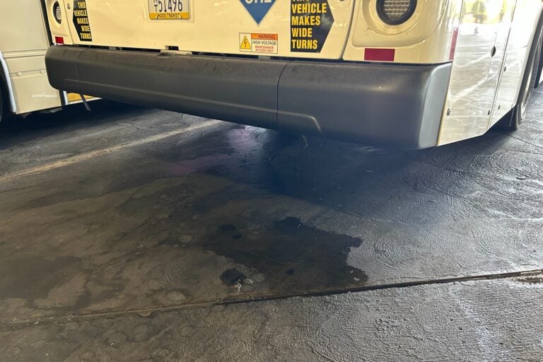 Water drips from below the bumper of SEPTA's new fuel cell electric bus. (Sophia Schmidt/WHYY)