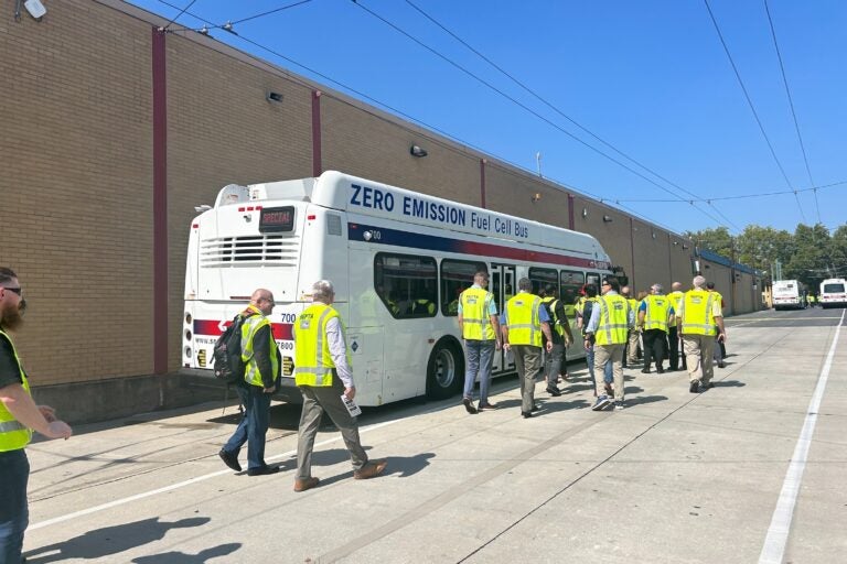 Employees with SEPTA and other transit agencies board SEPTA's new fuel cell electric bus during the Zero Emission Bus Conference in August. (Sophia Schmidt/WHYY)