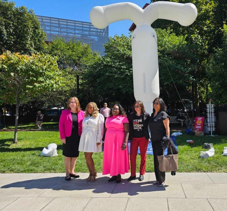 Philly City Councilmembers appear in front of a giant inflatable IUD