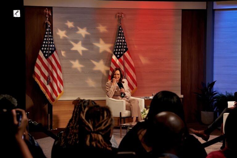 Kamala Harris sits and looks at the audience