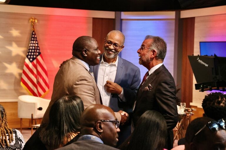 Bill Marrazzo greets NABJ President Ken Lemon next to another person