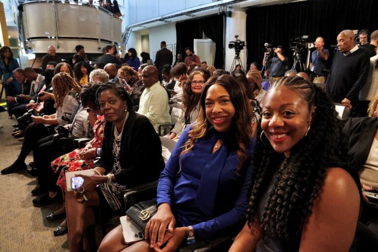 Cherri Gregg and Amanda Fitzpatrick smile while sitting in the crowd