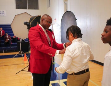 Kappa Alpha Psi Fraternity Inc. members check the ties on students at 'Kappa League