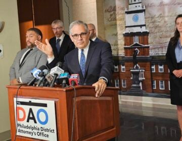 Larry Krasner speaks behind a podium