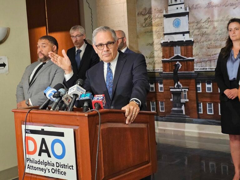 Larry Krasner speaks behind a podium