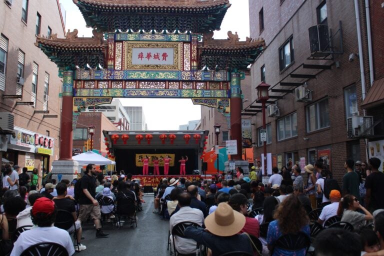 attendees watch a performance under the Chinatown Arch