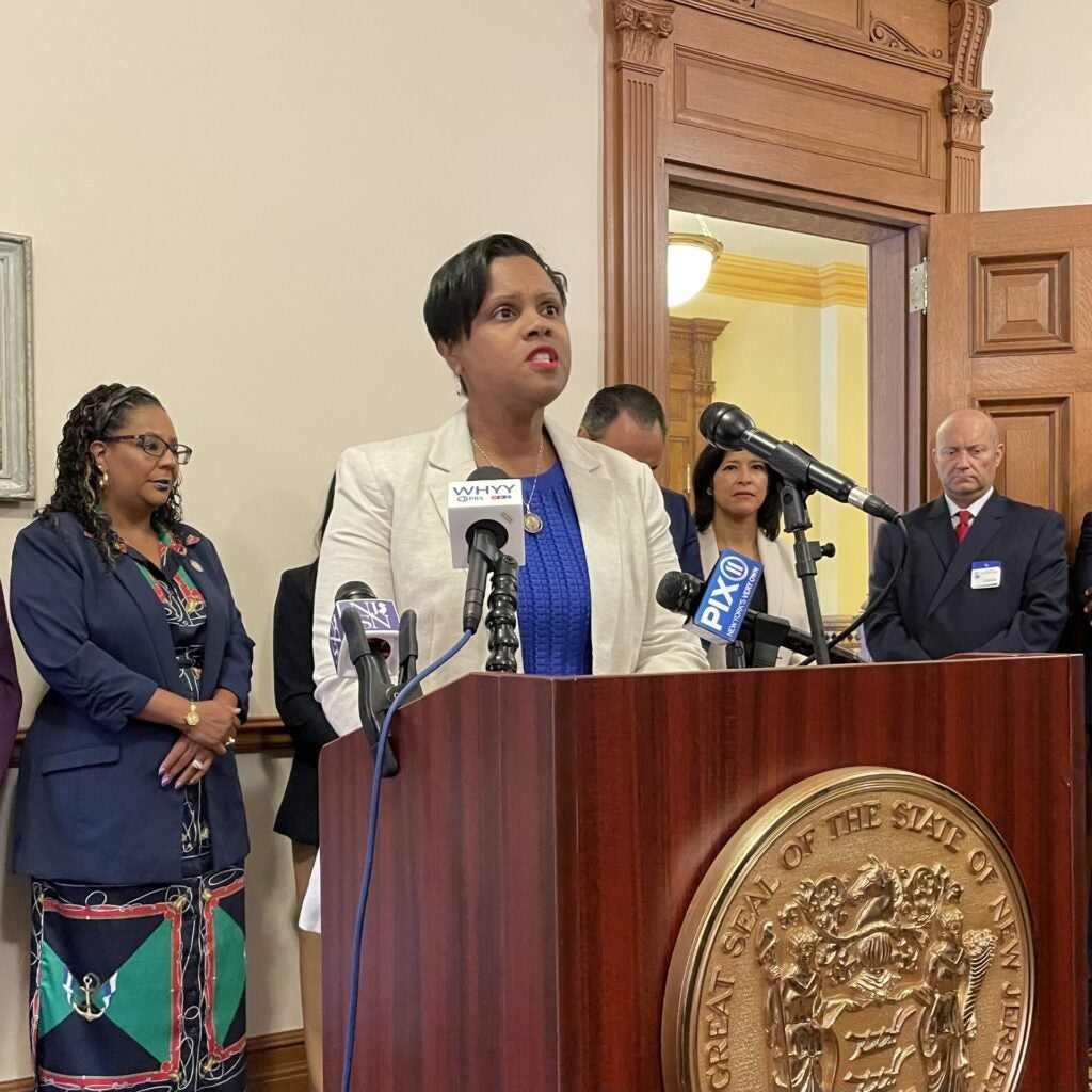 Shavonda Sumter speaks behind a podium