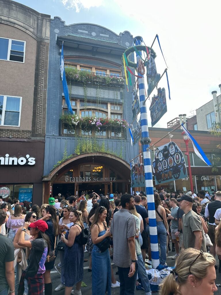 a crowd in front of Brauhaus Schmitz