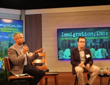 Anuj Gupta, left, CEO of The Welcoming Center, speaks with Zeke Hernandez, right, a professor at University of Pennsylvania's Wharton School of Business and author of 