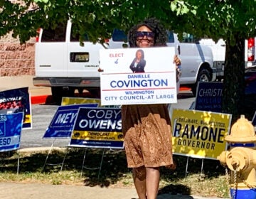 Woman holding a campaign sign for Danielle Covington