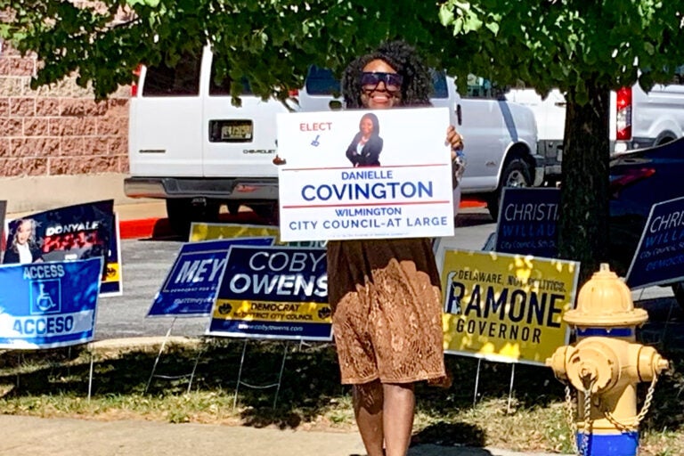 Woman holding a campaign sign for Danielle Covington