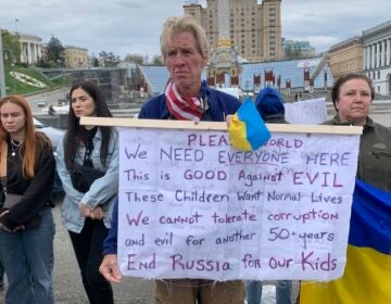 Ryan Wesley Routh holds up a banner during a rally in central Kyiv, Ukraine