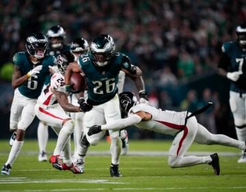 Philadelphia Eagles running back Saquon Barkley runs with the ball under pressure from Atlanta Falcons cornerback A.J. Terrell and safety Jessie Bates III during the second half on Monday, Sept. 16, 2024, in Philadelphia