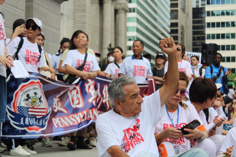 People sit and protest 76er Place in Philadelphia's Chinatown neighborhood