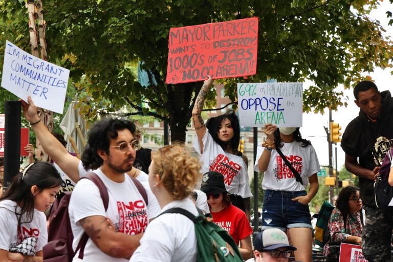 Activists outside Philadelphia City Hall react to Mayor Cherelle Parker’s announcement that she has reached an agreement to build a new Sixers arena in Center City adjacent to Chinatown. (Emma Lee/WHYY)