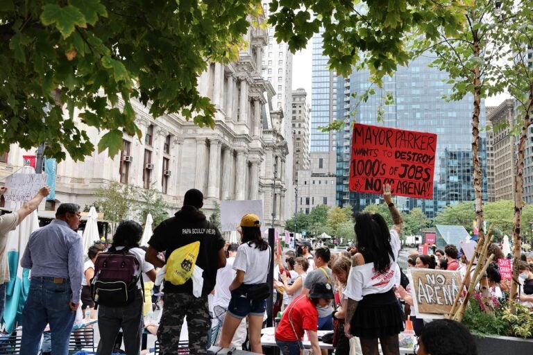 Activists outside Philadelphia City Hall react to Mayor Cherelle Parker’s announcement that she has reached an agreement to build a new Sixers arena in Center City adjacent to Chinatown. (Emma Lee/WHYY)