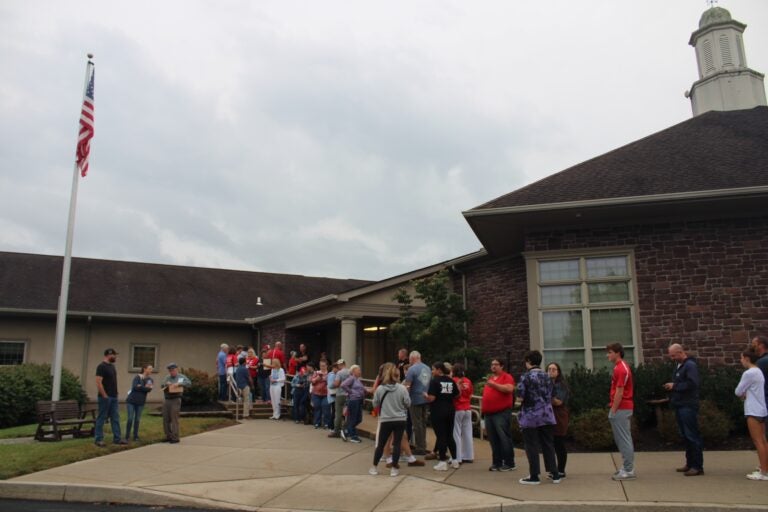 People line up outside a school board meeting in Souderton