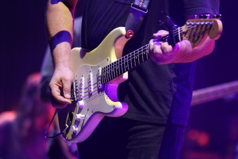 a close-up of a person playing guitar