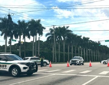 four sheriff vehicles are pictured near Trump International Golf Club