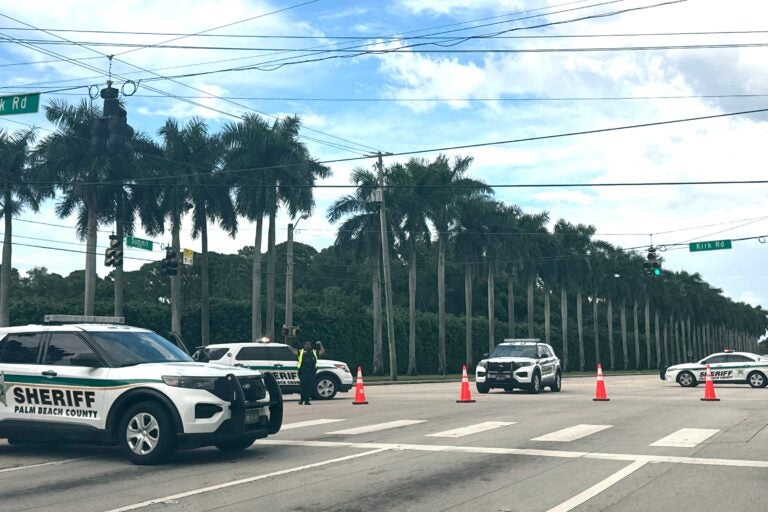 four sheriff vehicles are pictured near Trump International Golf Club