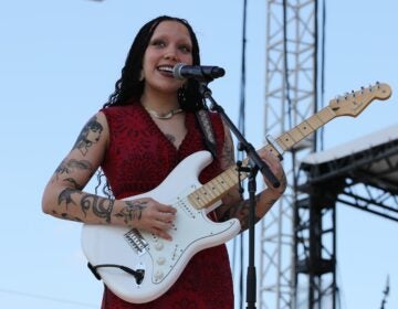 Julia Pratt playing guitar and singing