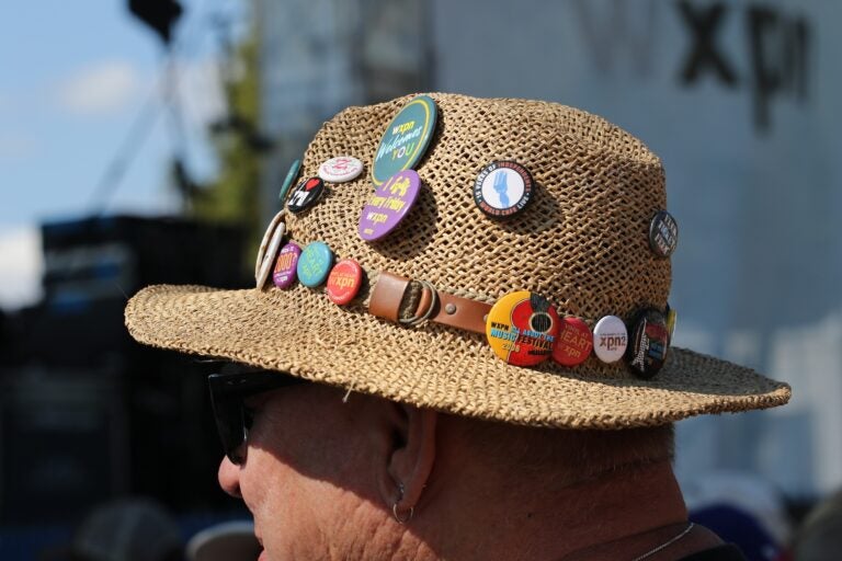 a hat with multiple pins on a person