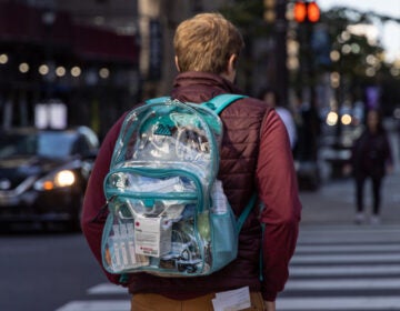 a person carrying a clear bag with first aid items