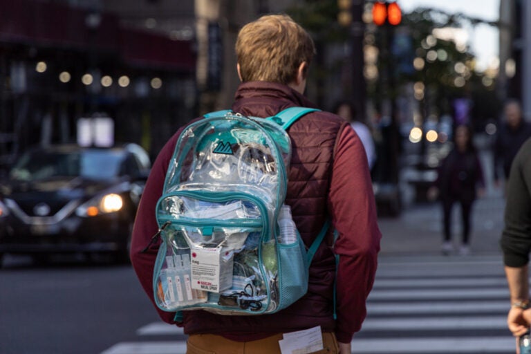 a person carrying a clear bag with first aid items