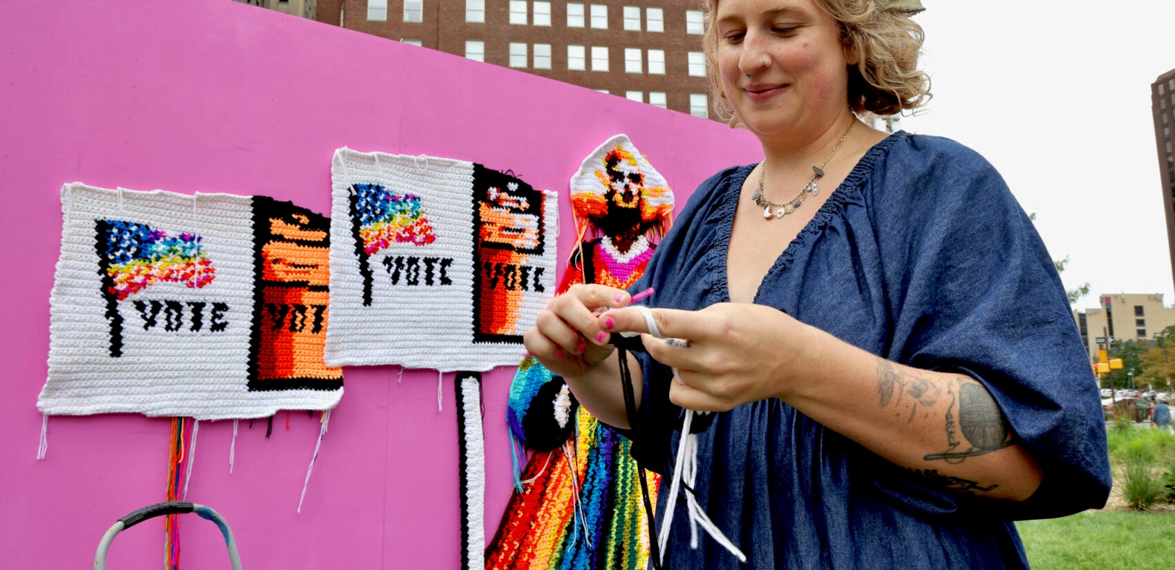 A woman crochets a mural in Love Park in Philadelphia