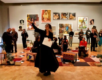 Renée Mussai, who curated ''Mickaline Thomas: All About Love,'' gives a tour of the exhibit at the Barnes Foundation in Philadelphia. (Emma Lee/WHYY)