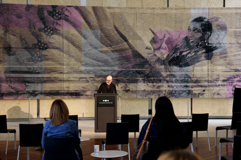 Barnes Foundation President Thom Collins stands before an embroidered portrait of Josephine Baker as he introduces the exhibit ''Mickaline Thomas: All About Love.'' Thomas's portrait of Baker was originally made for Dior's 2023 couture show in Paris.(Emma Lee/WHYY)