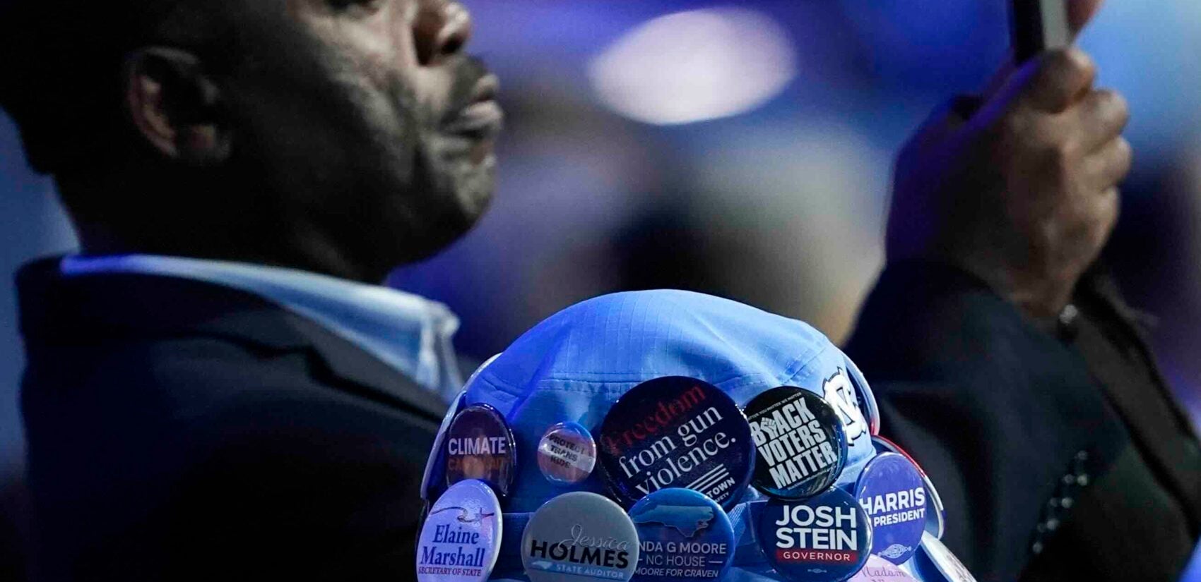 Delegates take photos during the Democratic National Convention Monday, Aug. 19, 2024, in Chicago. (AP Photo/Charles Rex Arbogast)