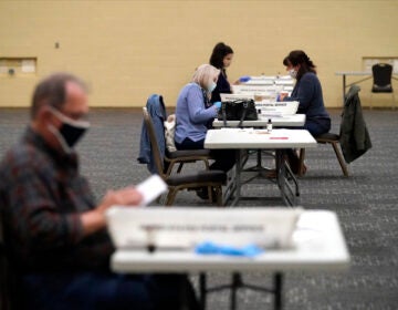 FILE - Workers prepare mail-in ballots for counting, Nov. 4, 2020, at the convention center in Lancaster, Pa. (AP Photo/Julio Cortez, File)