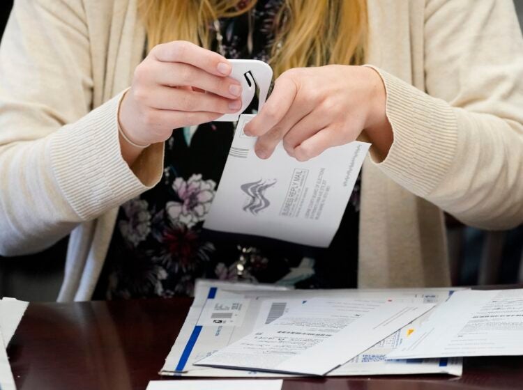 An election worker canvasses ballots