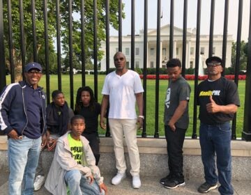 Students pose in front of the White House gates