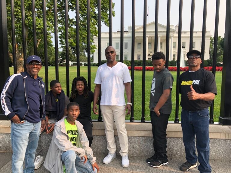 Students pose in front of the White House gates