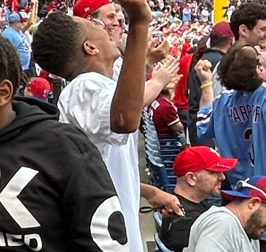 a student cheers at a Phillies game