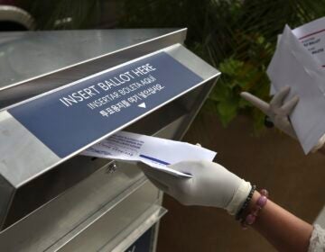 a mail ballot being dropped off
