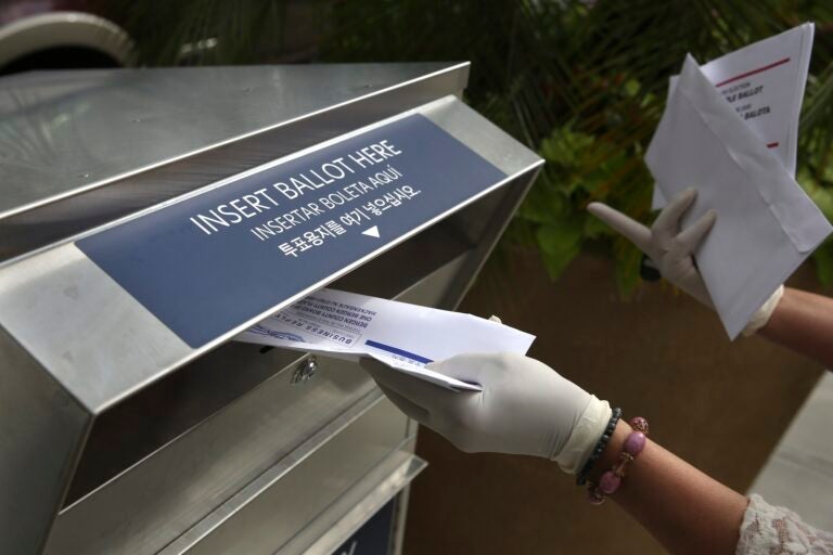 a mail ballot being dropped off