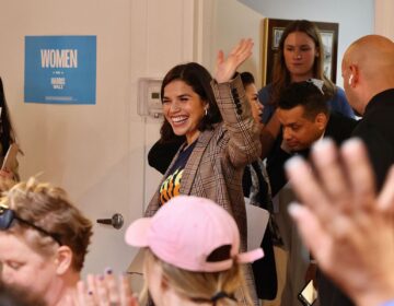 America Ferrera waving as she enters the room