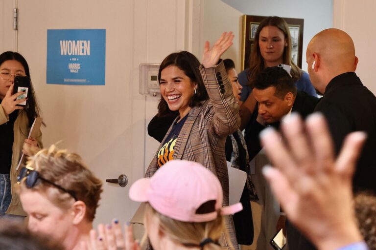 America Ferrera waving as she enters the room