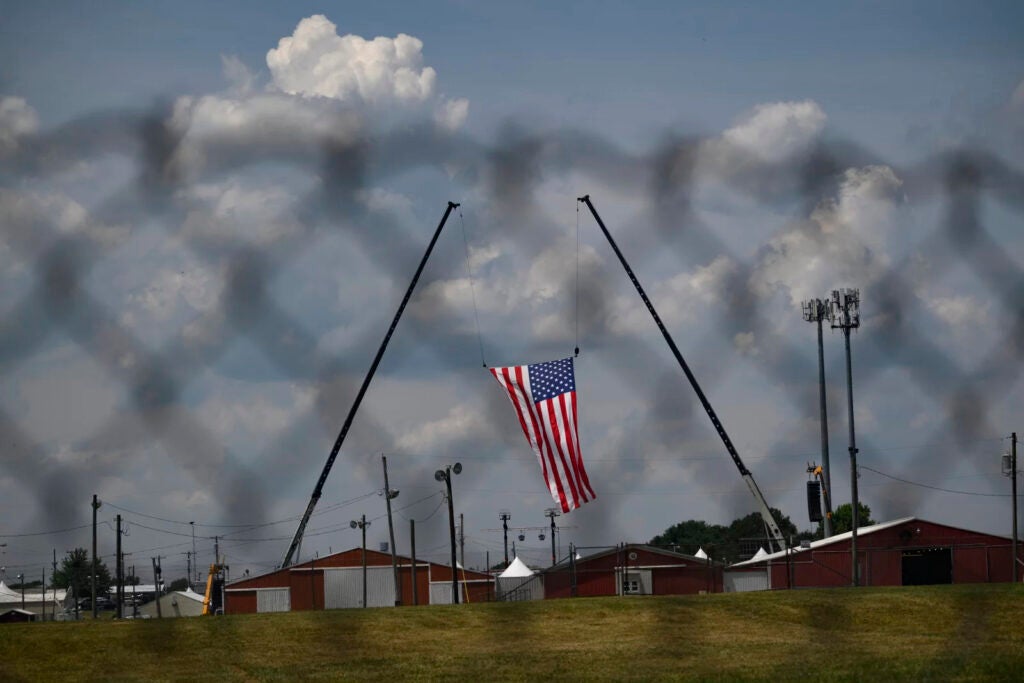 The American flag hangs from two cranes