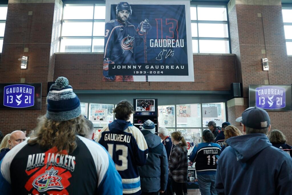 Fans look at a memorial of Gaudreau brothers