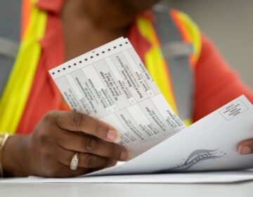 Absentee ballots held in someone's hands