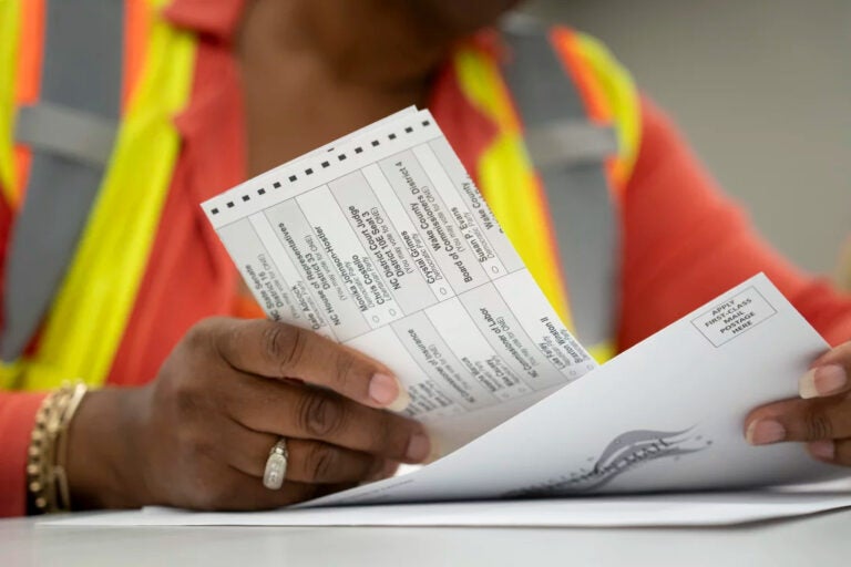 Absentee ballots held in someone's hands