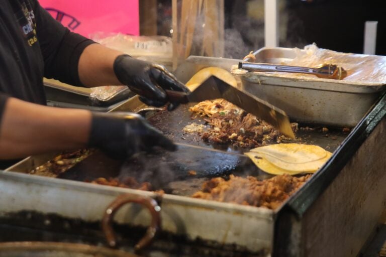 meat and tortillas being grilled