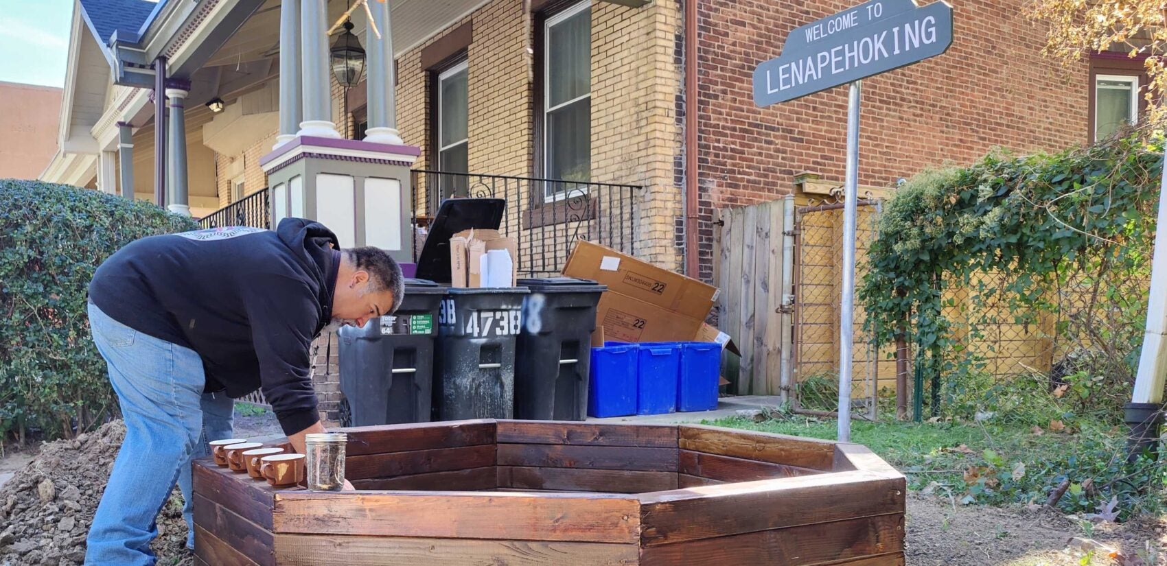 Tim Martin adds dirt to the raised bed