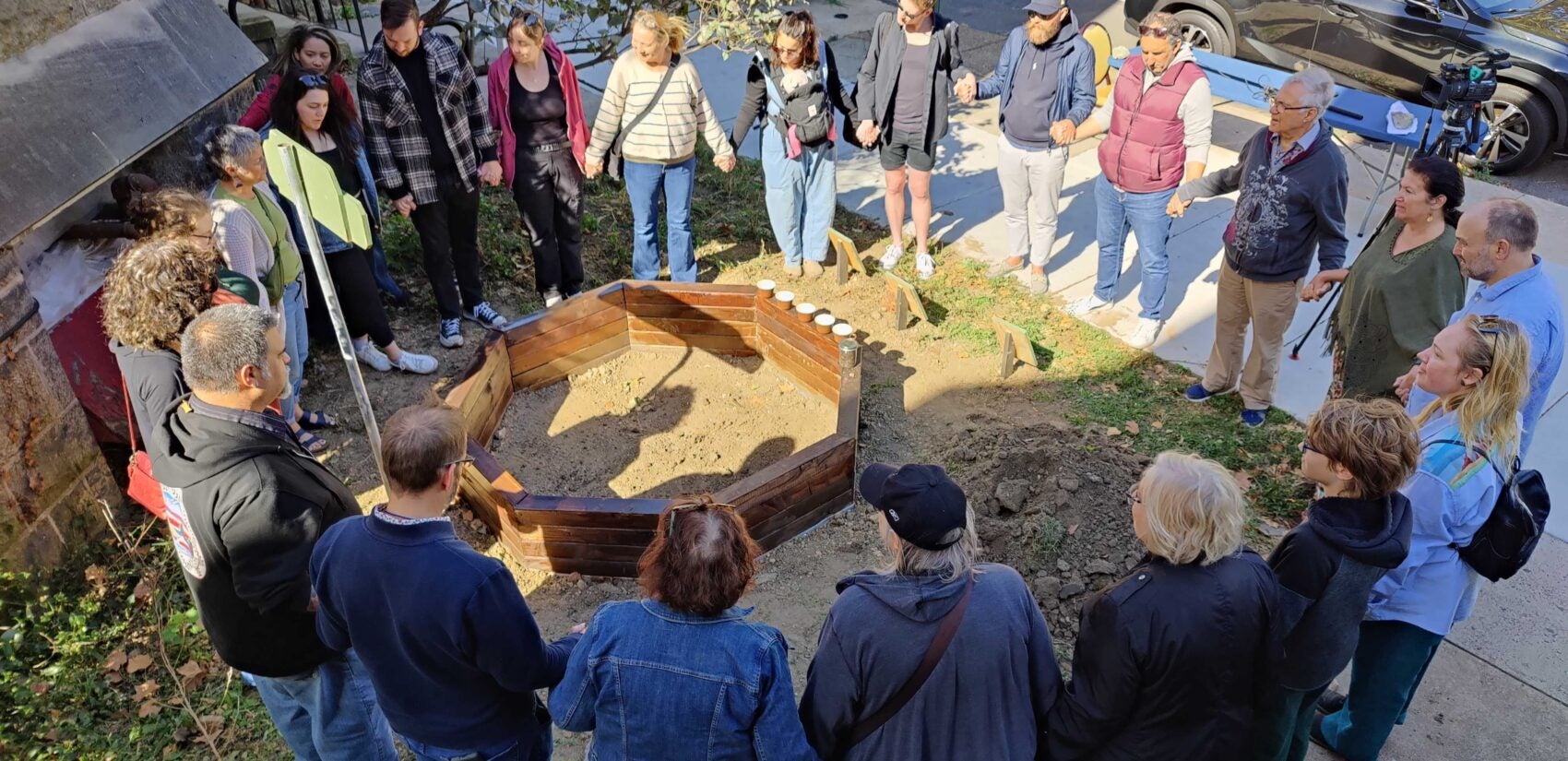 a circle of people around the raised bed