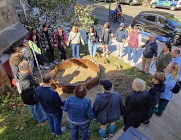 a circle of people around the raised bed