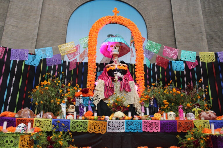 A centerpiece ofrenda remembering those who have died from breast cancer was created by artists Martín Anguiano, Dayesla Ixtli and María Felix Rosas Ramos. (Emily Neil/WHYY)